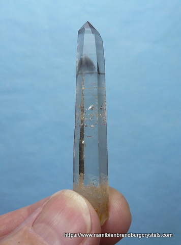 Quartz crystal with smoky phantom and negative crystal inclusions