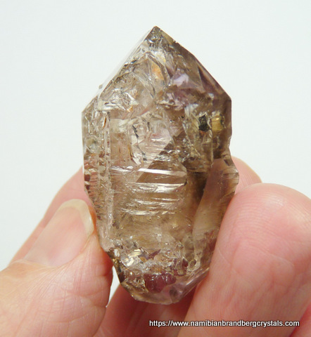 Light window quartz crystal with interesting growth patterns
