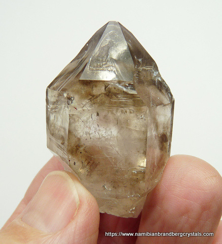 Quartz crystal with patches of smoky colouring