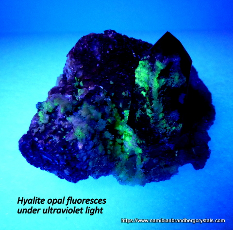 Dark smoky crystal with hyalite opal on mica matrix