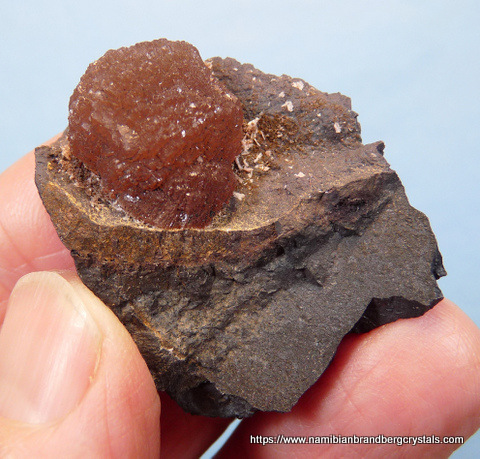 Neat ball of olmiite on manganite