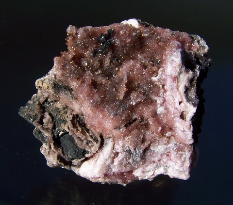 Gemmy, sparkling rhodochrosite crystals on rhodochrosite and manganite matrix