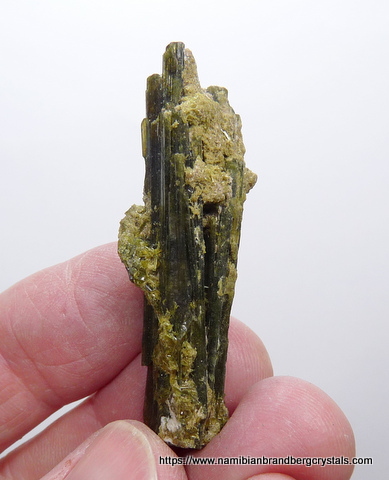 A green epidote crystal with minute crystals on its surface