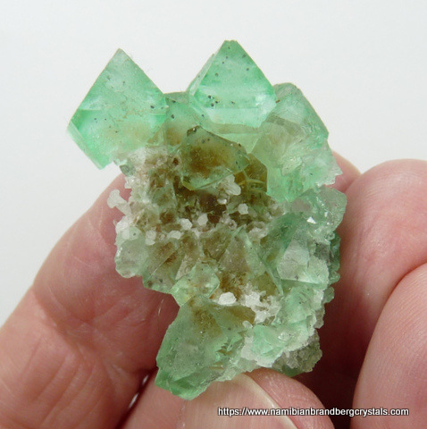 Green fluorite crystal group with inclusions