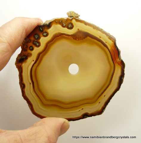 A slice of polished agate with a hole