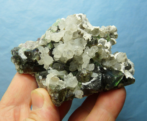 Quartz and greenish fluorite crystals with feldspar, on matrix