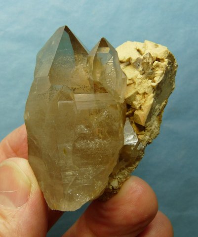 A group of light smoky crystals on feldspar